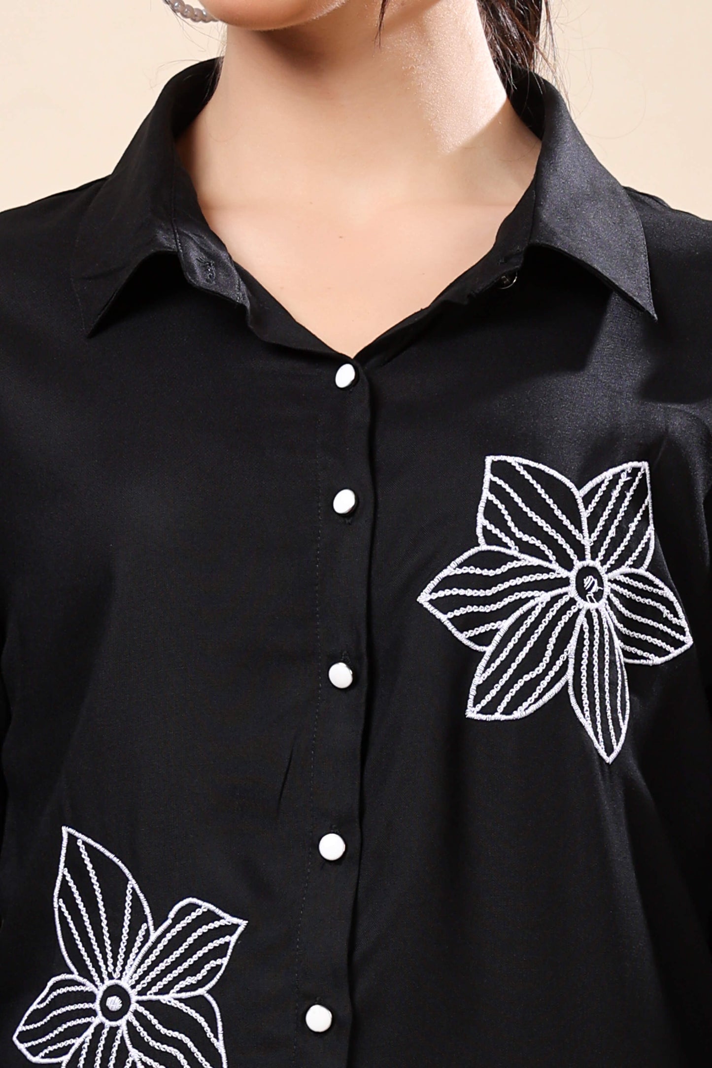 Close-up of white floral embroidery on Rabric black co-ord set