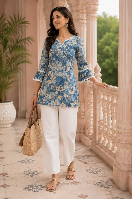 Stylish Indian woman wearing blue floral cotton short top with white pants in casual ethnic look