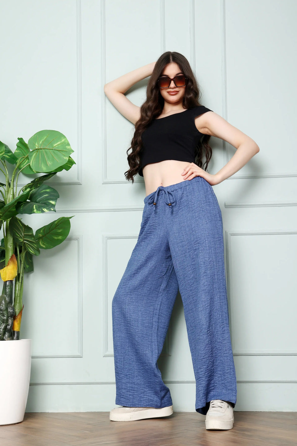 RABRIC Denim Blue linen women trousers standing angled pose with relaxed wide leg fit