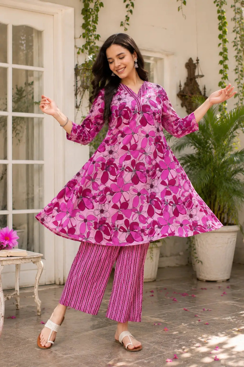 Women twirling in flared pink floral cotton kurta pant set showing beautiful kurta flair and elegant ethnic fashion