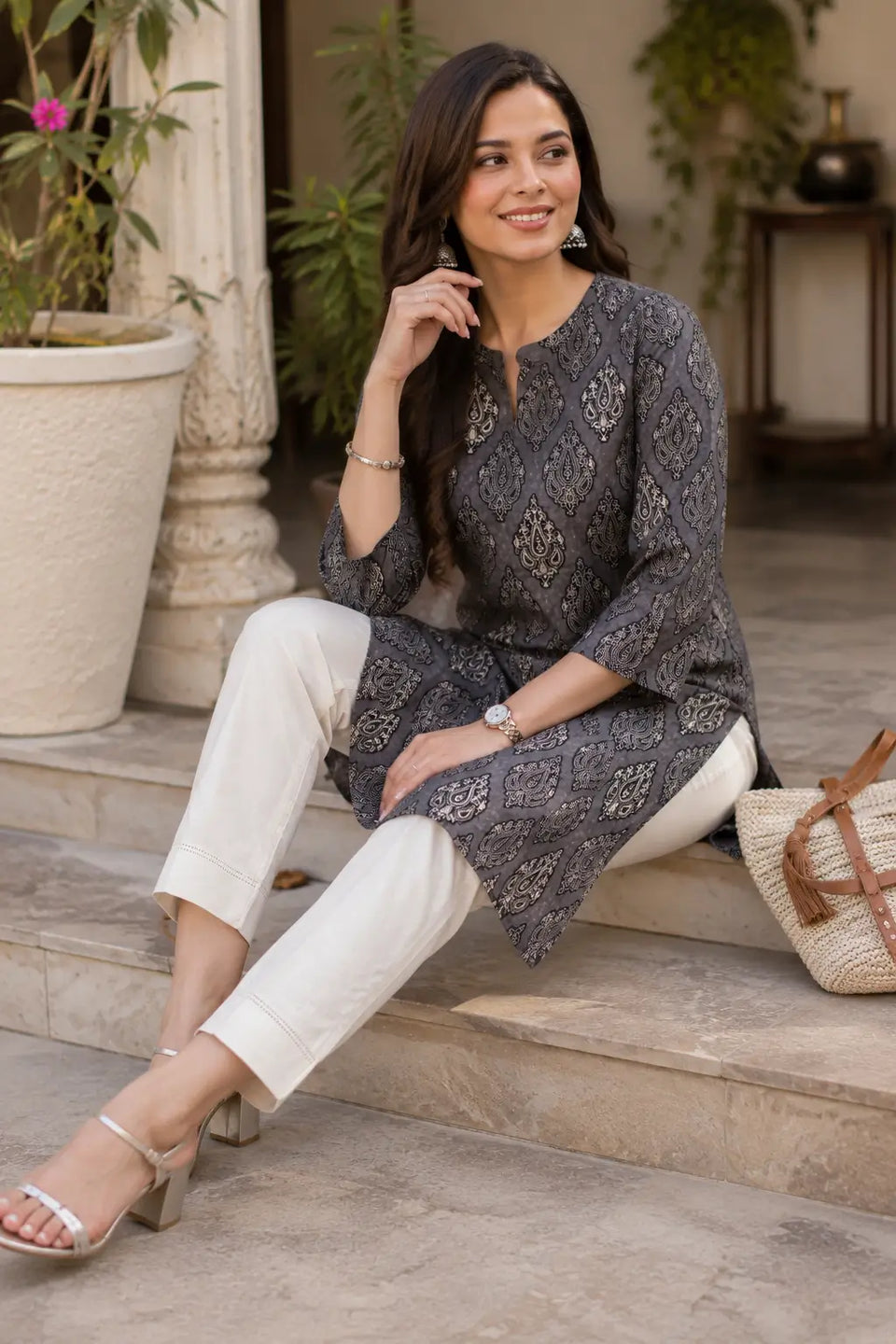 Woman wearing Rabric grey cambric printed kurti in casual sitting pose with stylish accessories and elegant ethnic fashion styling
