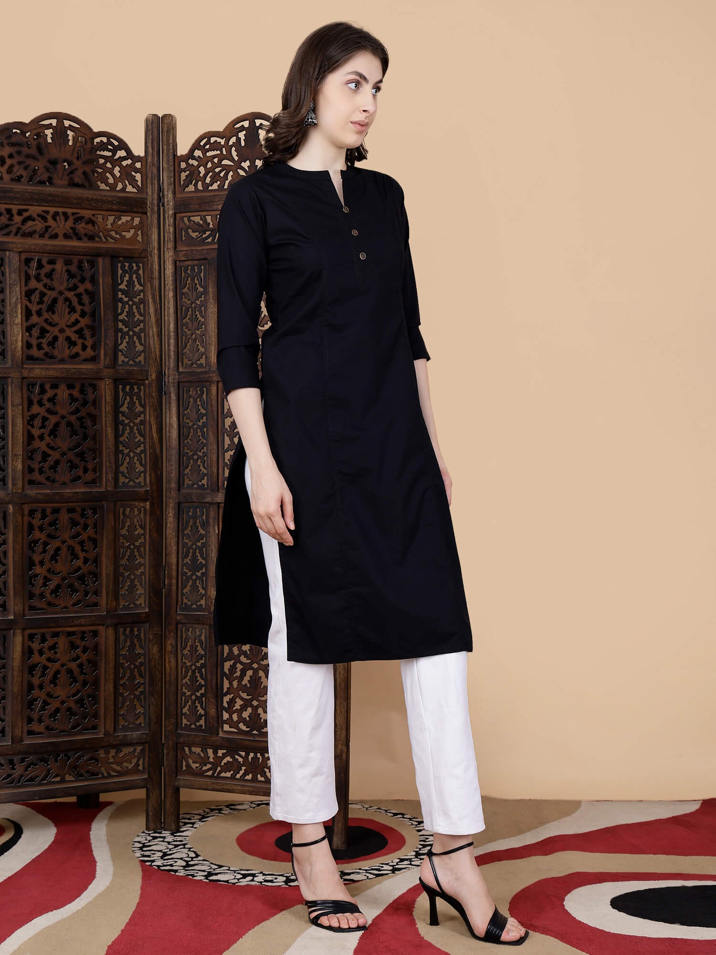 Close-up of round neck with brass buttons and thread work design