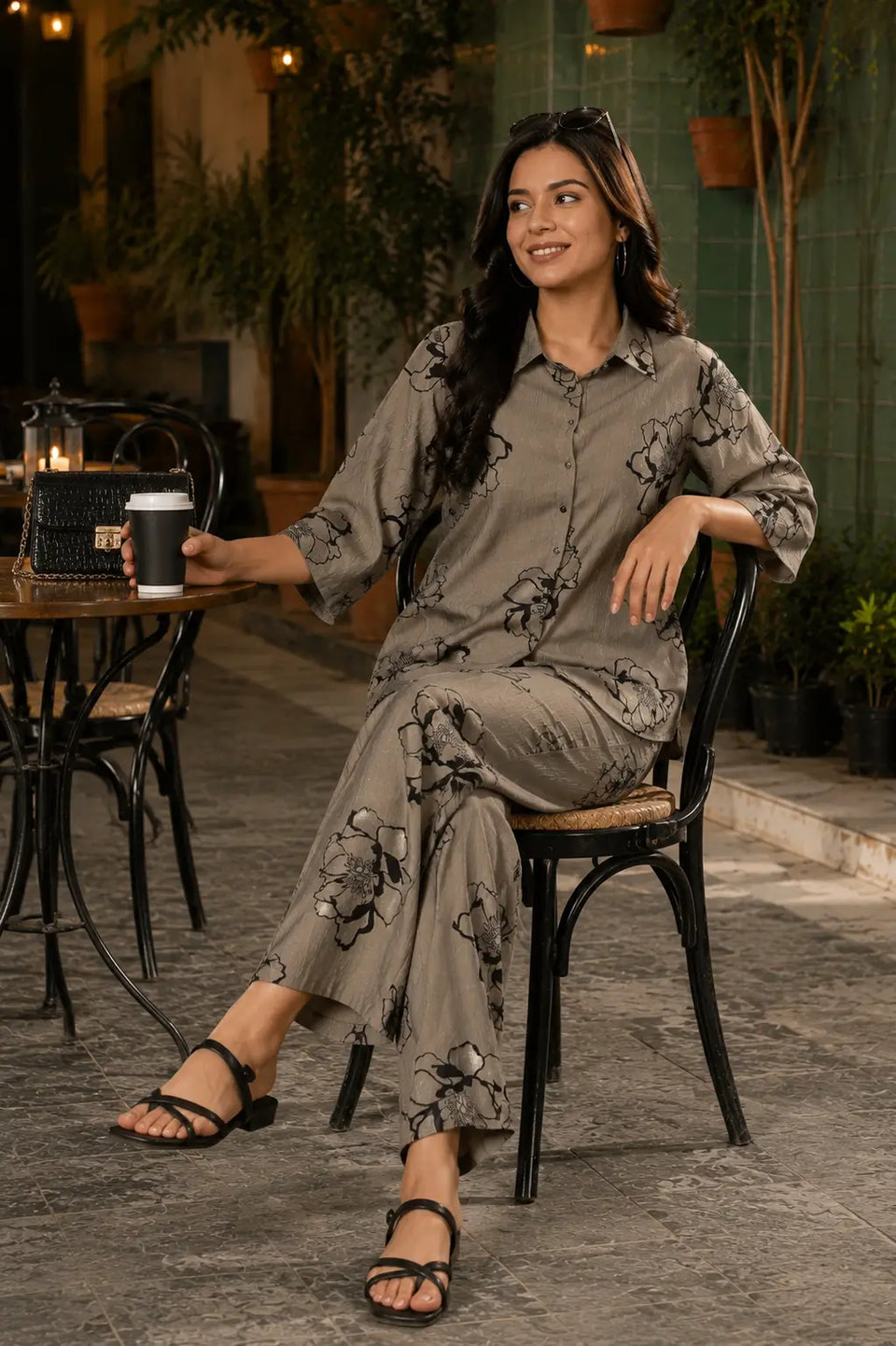 Rabric taupe grey Vertican Silk floral print co-ord set sitting lifestyle image with casual accessories