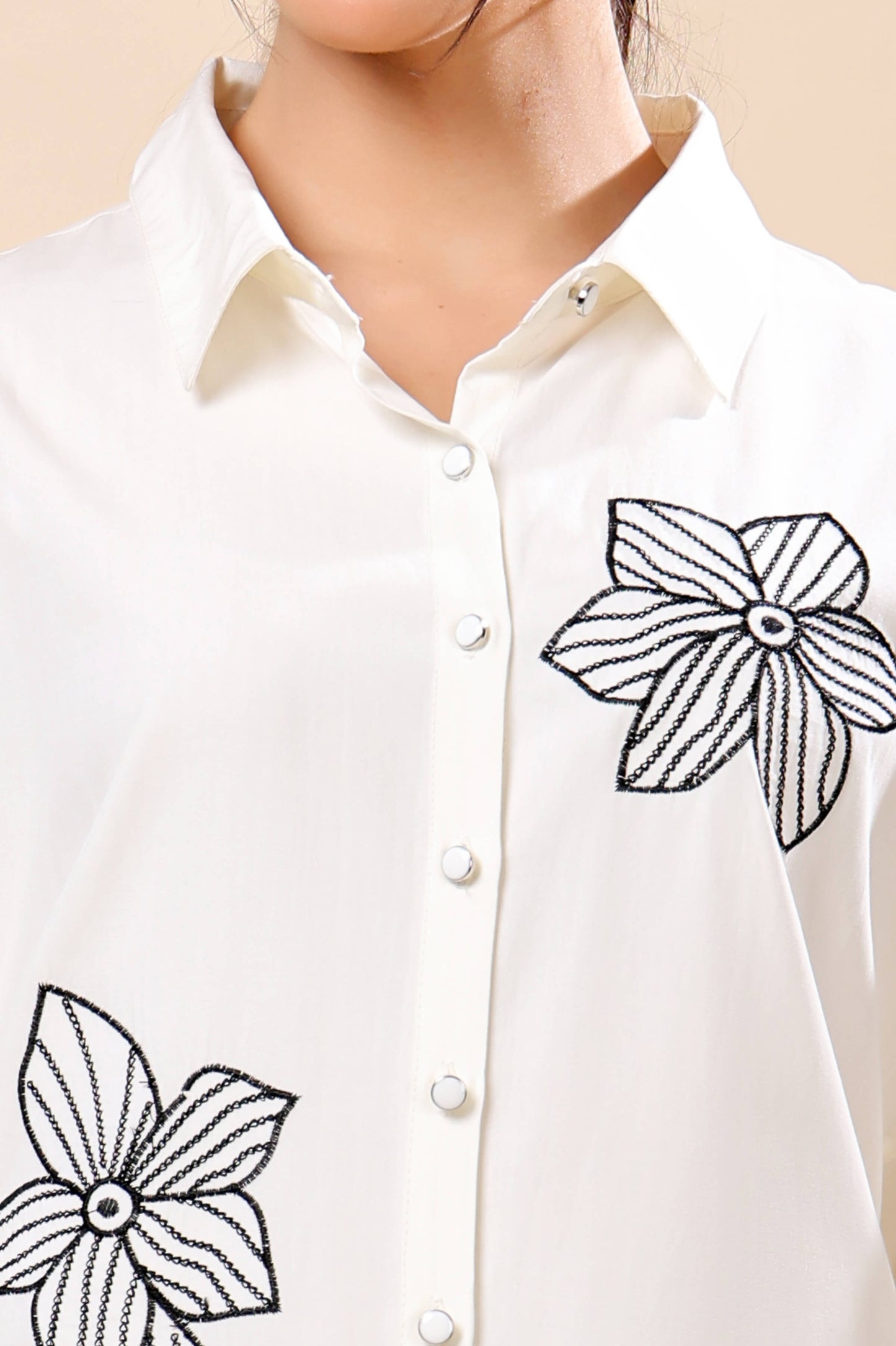 Close-up of black floral embroidery on Rabric white co-ord set