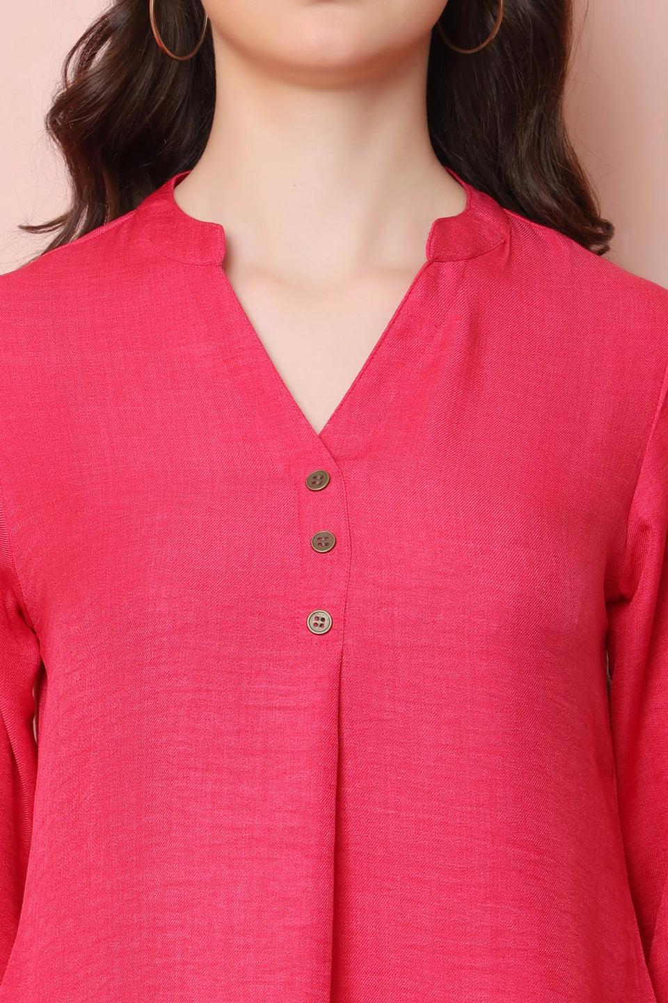 Close-up of RABRIC coral pink twill co-ord set showing the notched neckline, three buttons and fabric texture