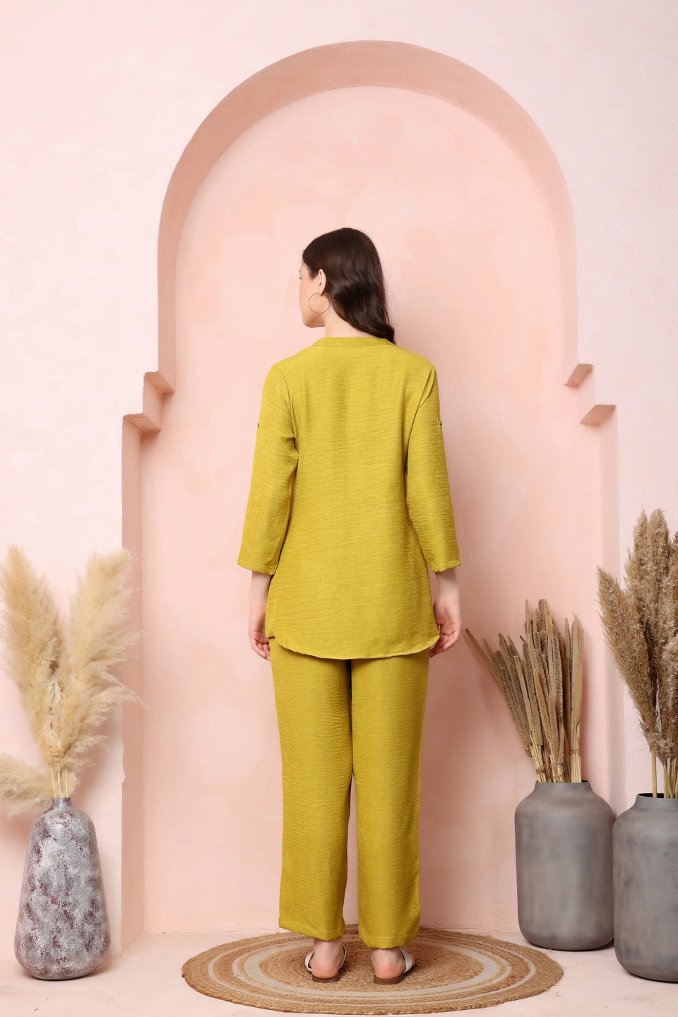 Back view of RABRIC mustard yellow twill co-ord set showing the curved top hem and wide-leg trousers.