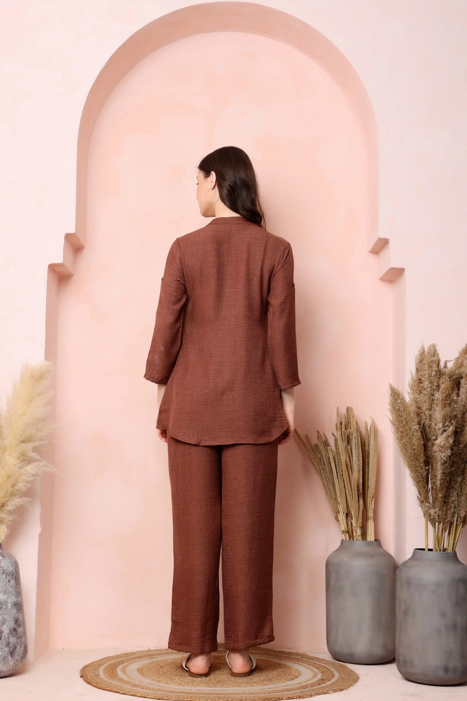 Back view of RABRIC rust brown twill co-ord set showing the curved top hem and wide-leg trousers