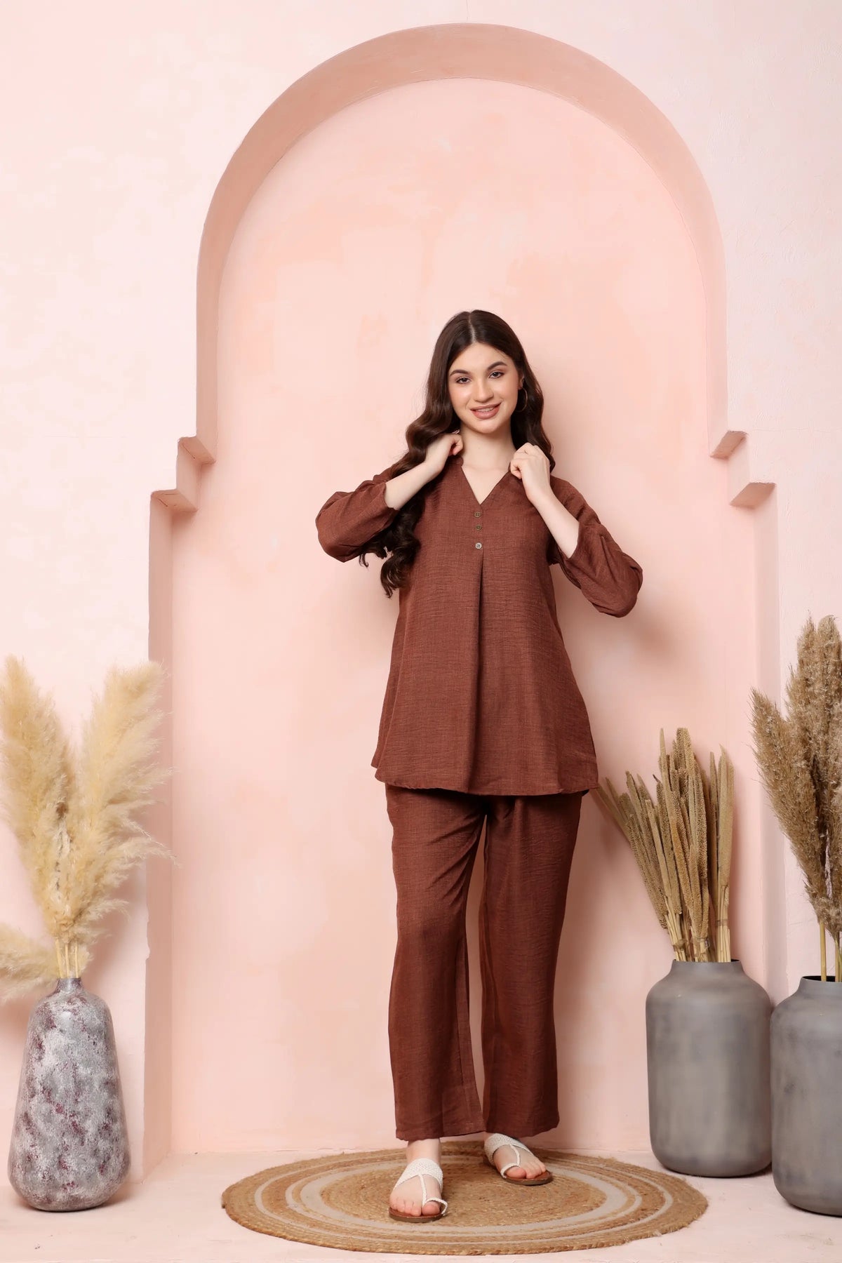 Full-length standing pose in RABRIC rust brown twill co-ord set showing the matching top and trousers.