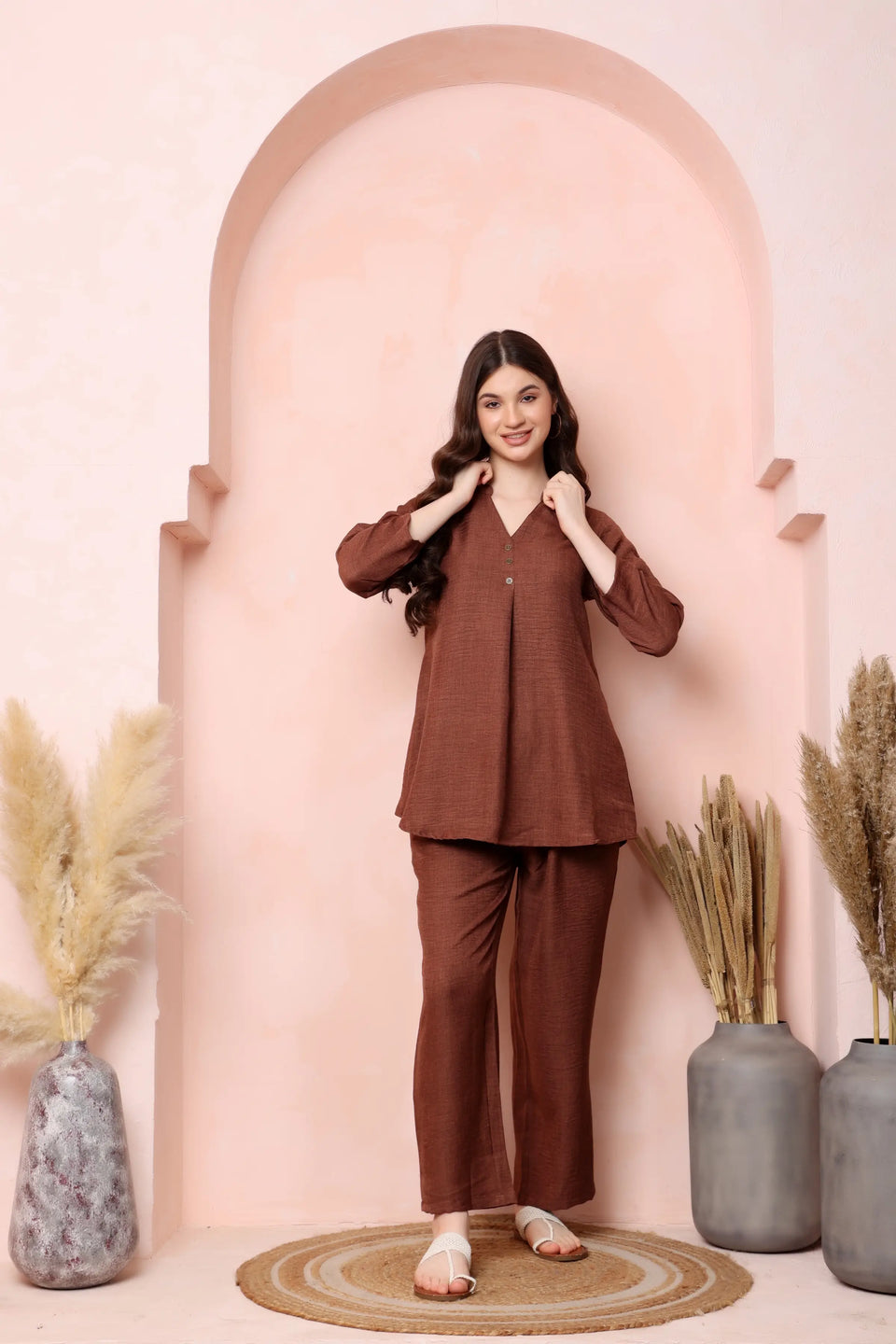 Full-length standing pose in RABRIC rust brown twill co-ord set showing the matching top and trousers.