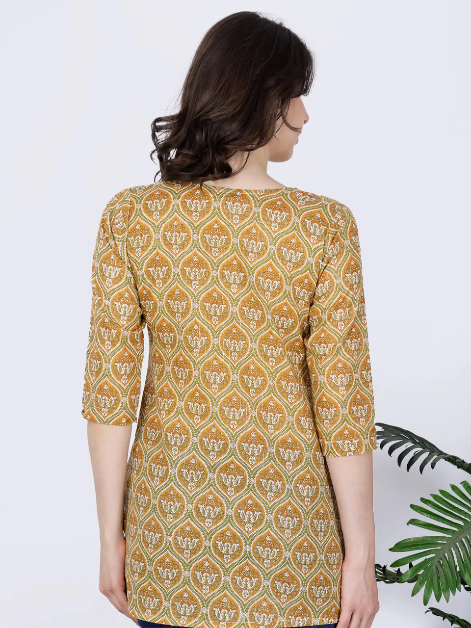 Back view of mustard yellow short kurti with ethnic print