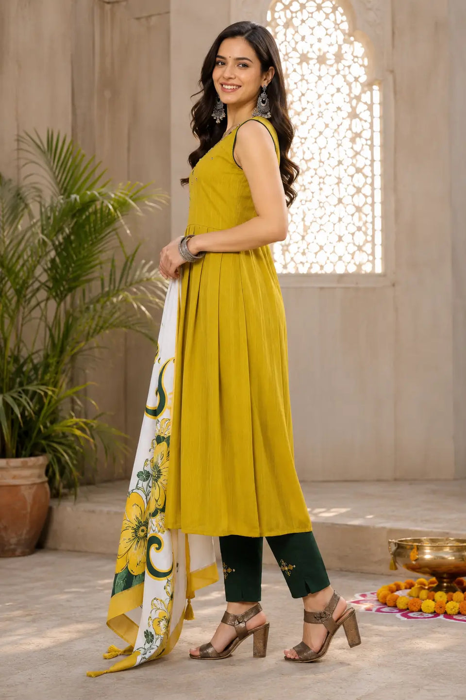 Side angle of mustard yellow sleeveless cotton long flair kurta pant set with dupatta by Rabric