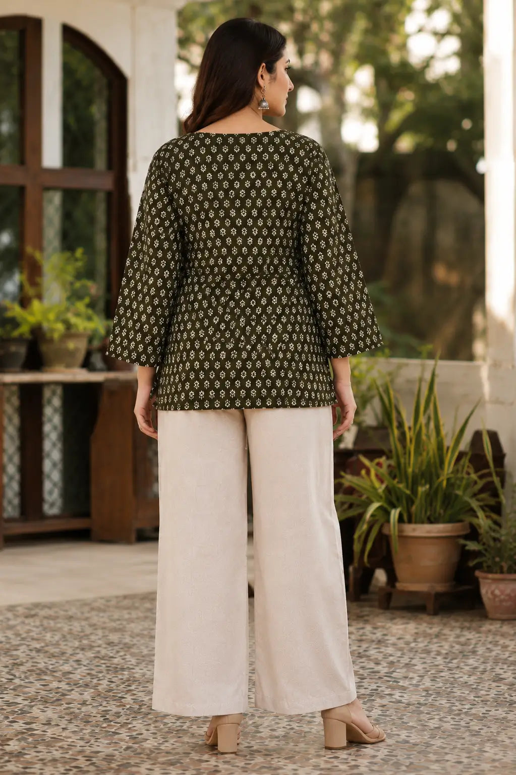 Rabric olive green Cotton short top for women with white floral print, hip length fit, full bell sleeves and plain back design.