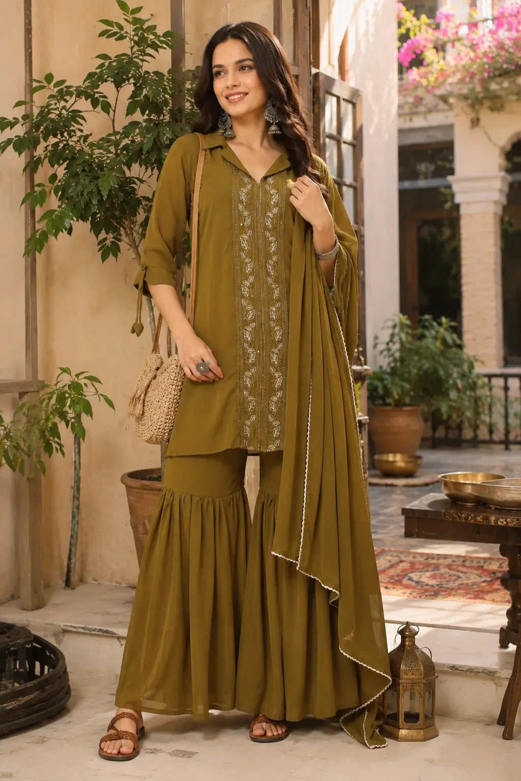 Woman wearing olive green satin ethnic kurta sharara set with dupatta in elegant lifestyle fashion look by Rabric