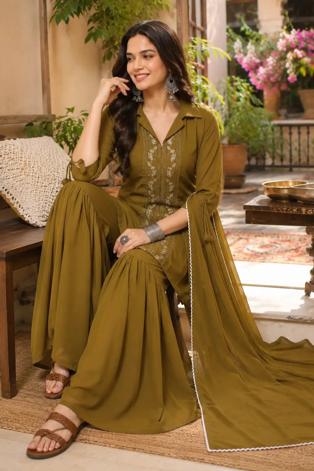 Woman wearing olive green satin ethnic kurta sharara set with dupatta in elegant lifestyle fashion look by Rabric