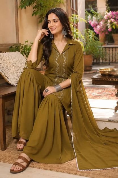 Woman wearing olive green satin ethnic kurta sharara set with dupatta in elegant lifestyle fashion look by Rabric