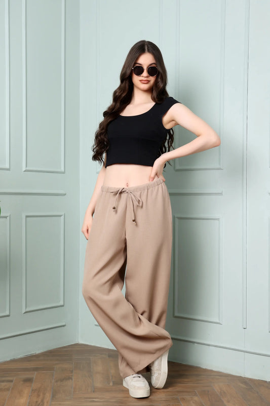 RABRIC beige linen trousers for women walking view showing comfortable relaxed wide leg fit