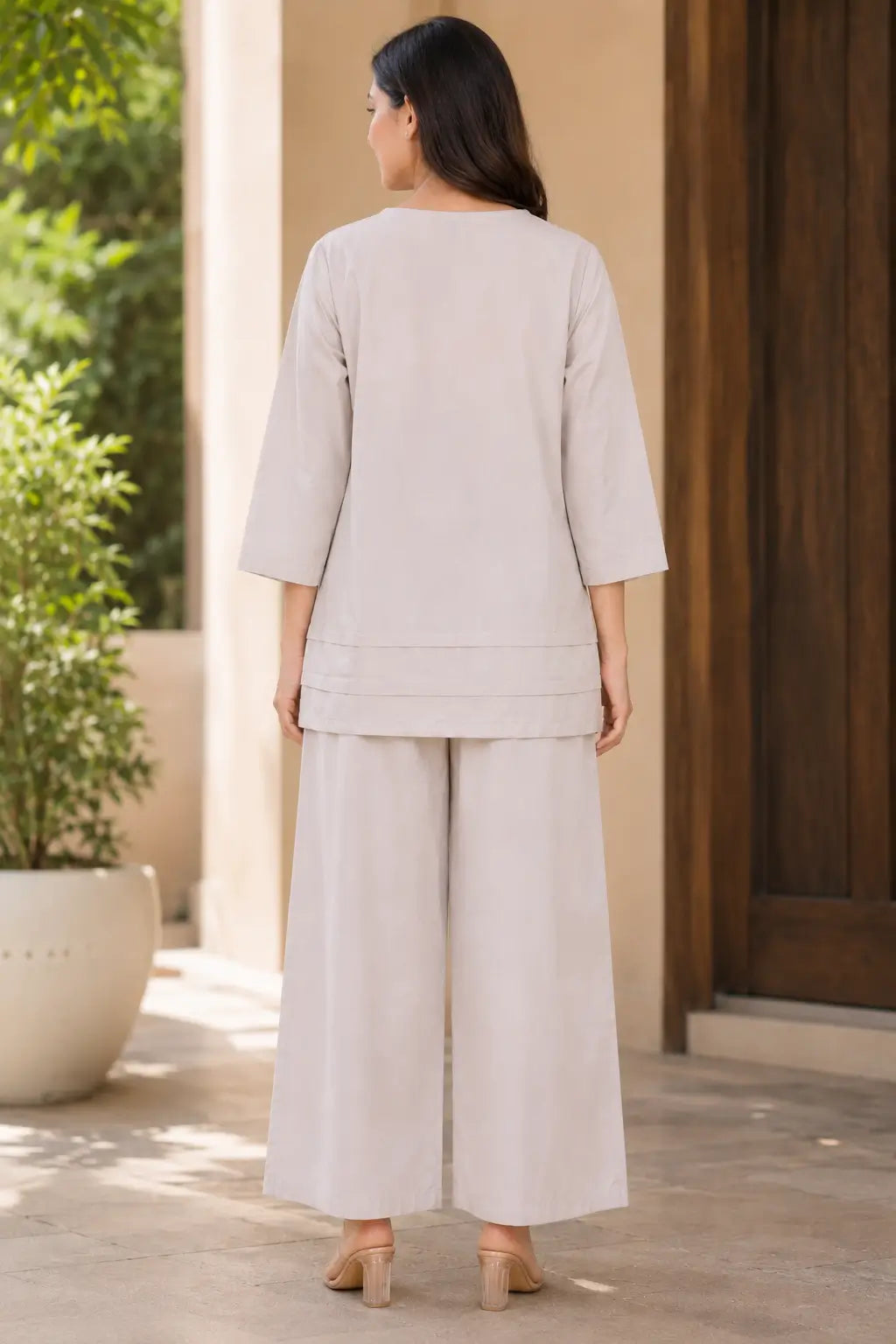 Back view of Rabric beige solid cotton co-ord set for women featuring plain solid top, 3/4 sleeves and wide leg palazzo pants