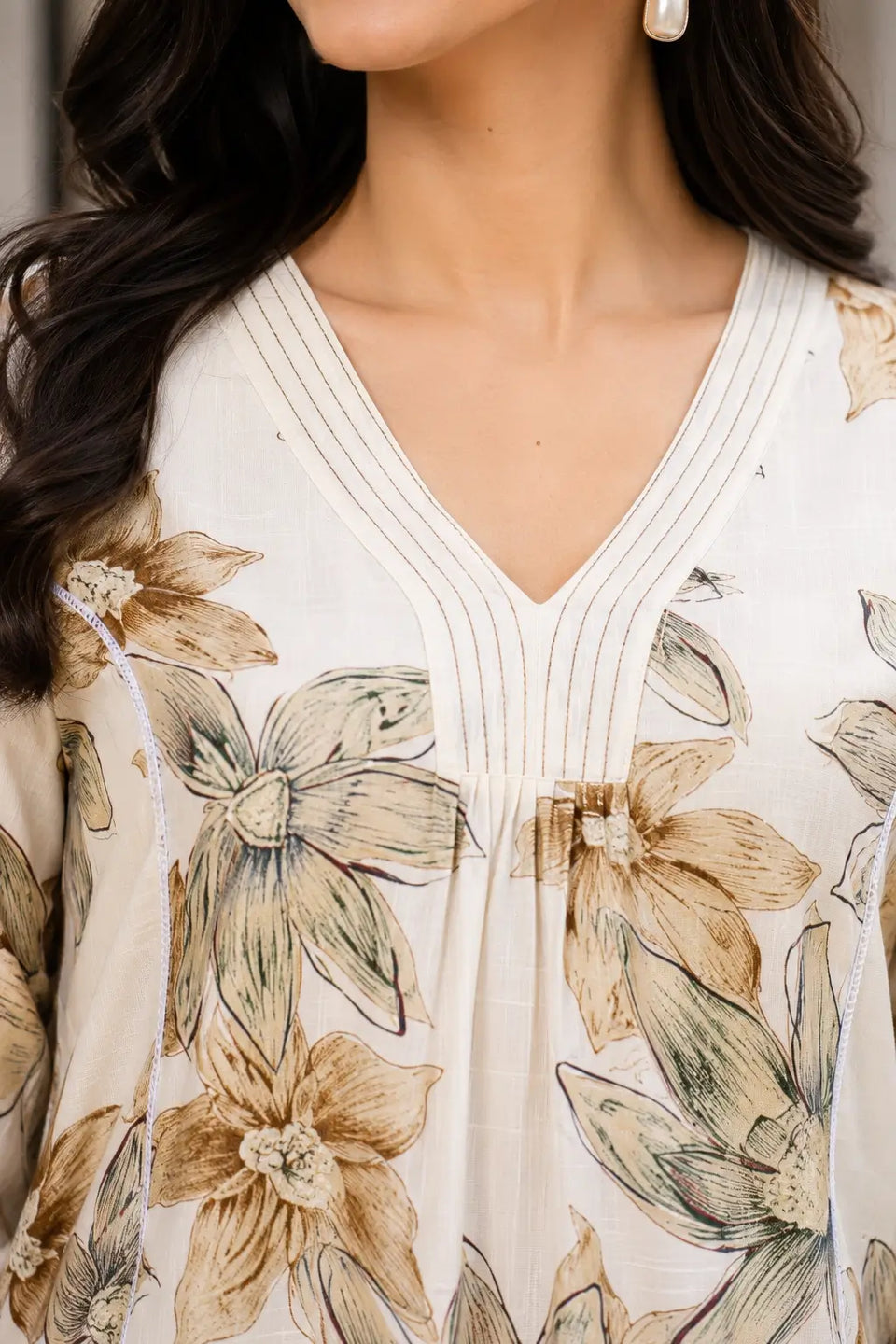 Close-up neckline detail of Rabric beige Vertican Silk floral printed women co-ord set with stylish V-neck stitching design.