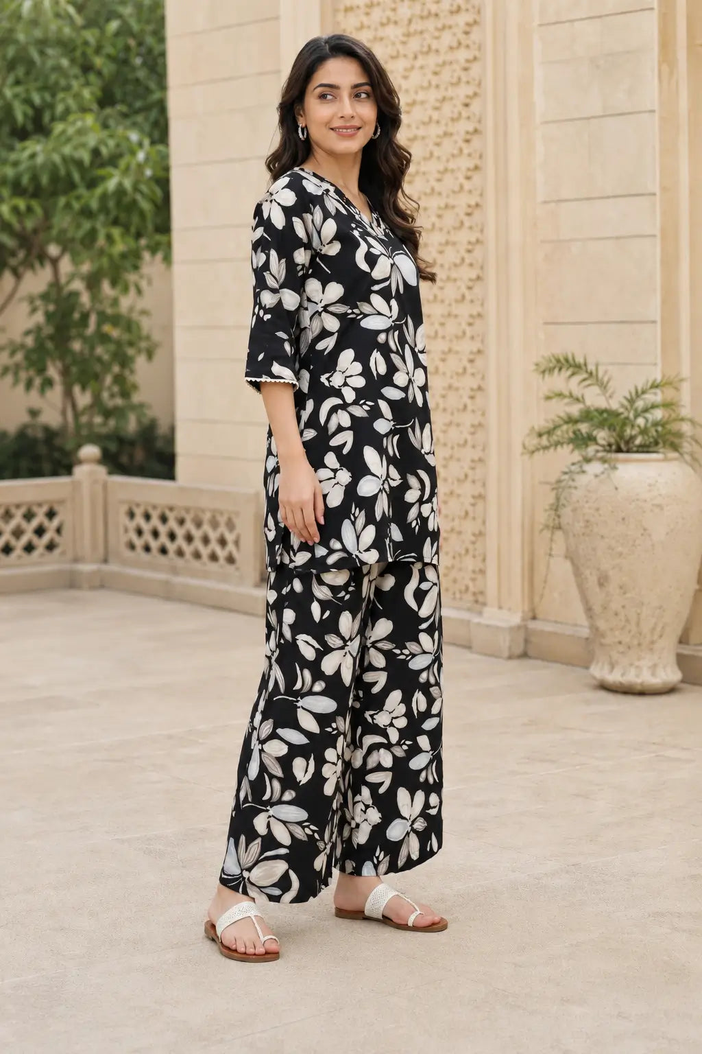 Side angle view of Rabric black and beige floral print cotton co-ord set for women with V-neck top and comfortable wide leg palazzo pants
