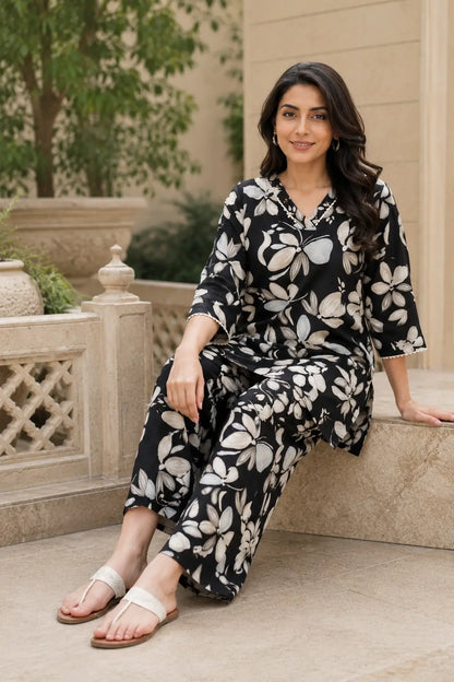 Indian model wearing Rabric black and beige floral print cotton co-ord set in a stylish sitting pose showcasing comfortable wide leg pants