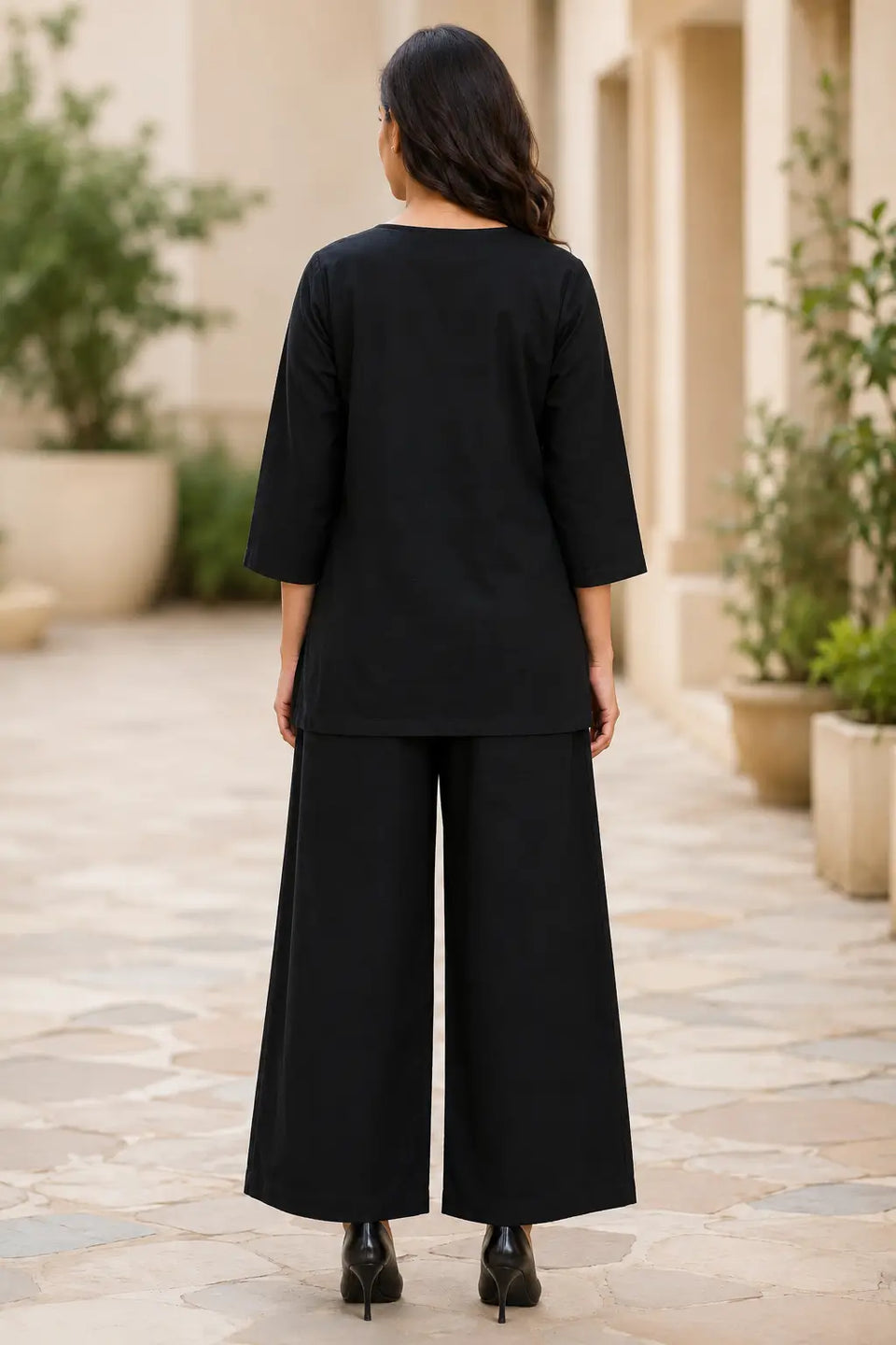 Back view of Rabric black cotton co-ord set for women featuring solid plain cotton fabric, relaxed top and wide-leg palazzo pants