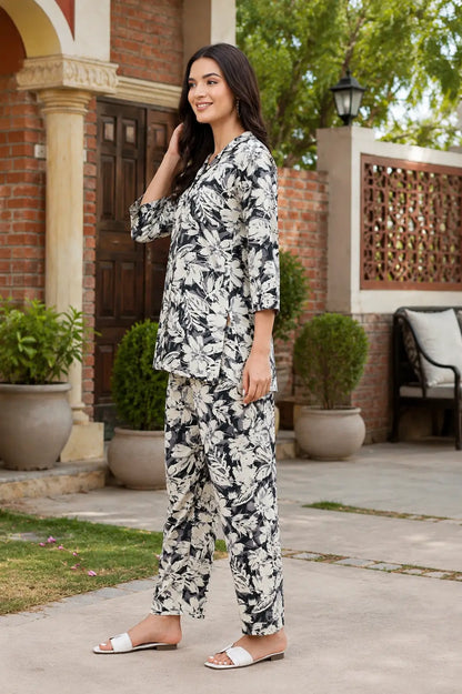 Side angle view of Rabric women rayon floral print co-ord set in black and cream with stylish casual fit and 3/4 sleeves