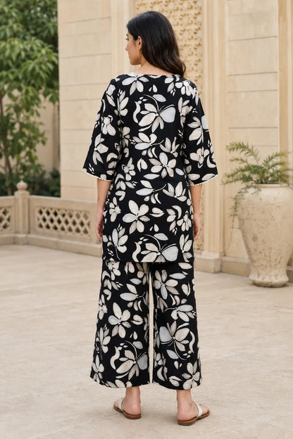 Back view of Rabric black floral print cotton co-ord set for women with short length top, 3/4 sleeves and matching wide leg palazzo pants