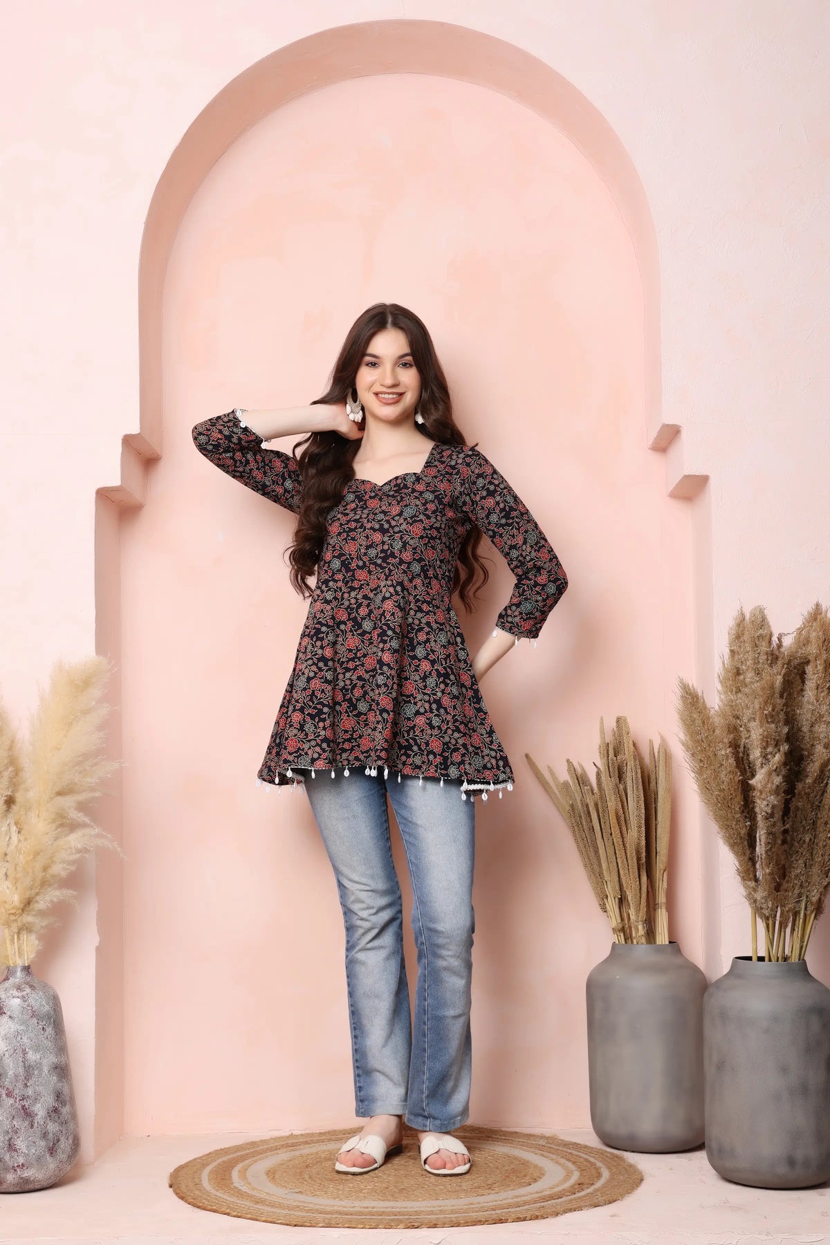 Woman wearing RABRIC black floral pure cotton short kurti in a casual lifestyle look