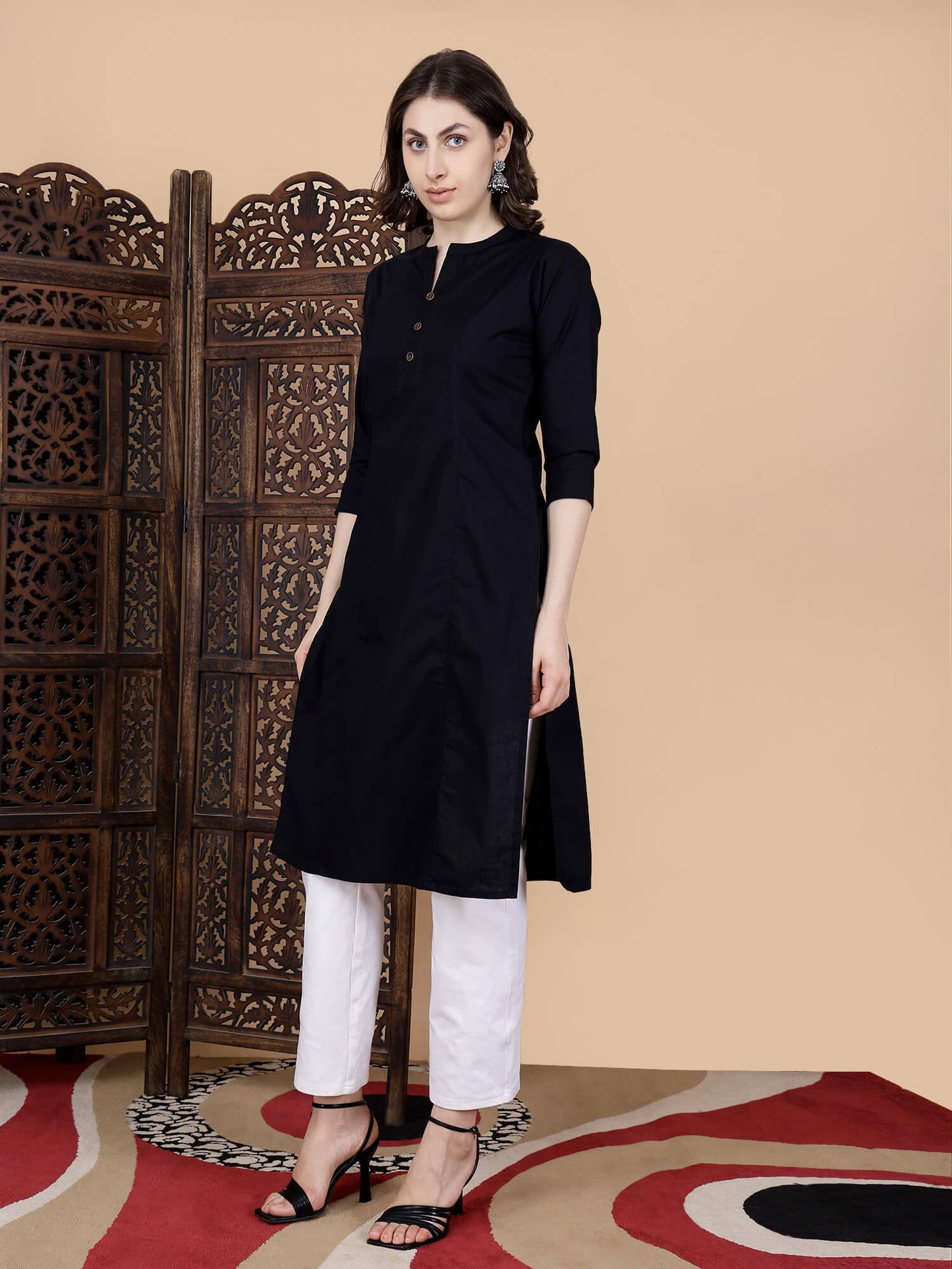 Detailed view of brass button embellishment on black kurti