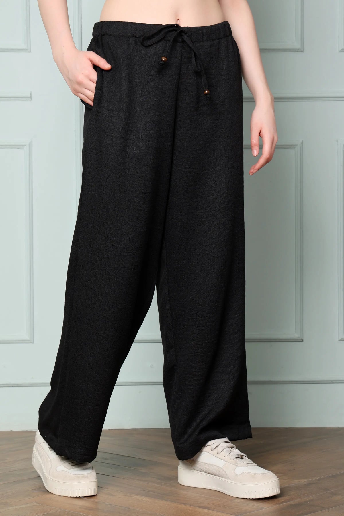 RABRIC black linen trousers for women side angle with broad wide leg silhouette and drawstring waist