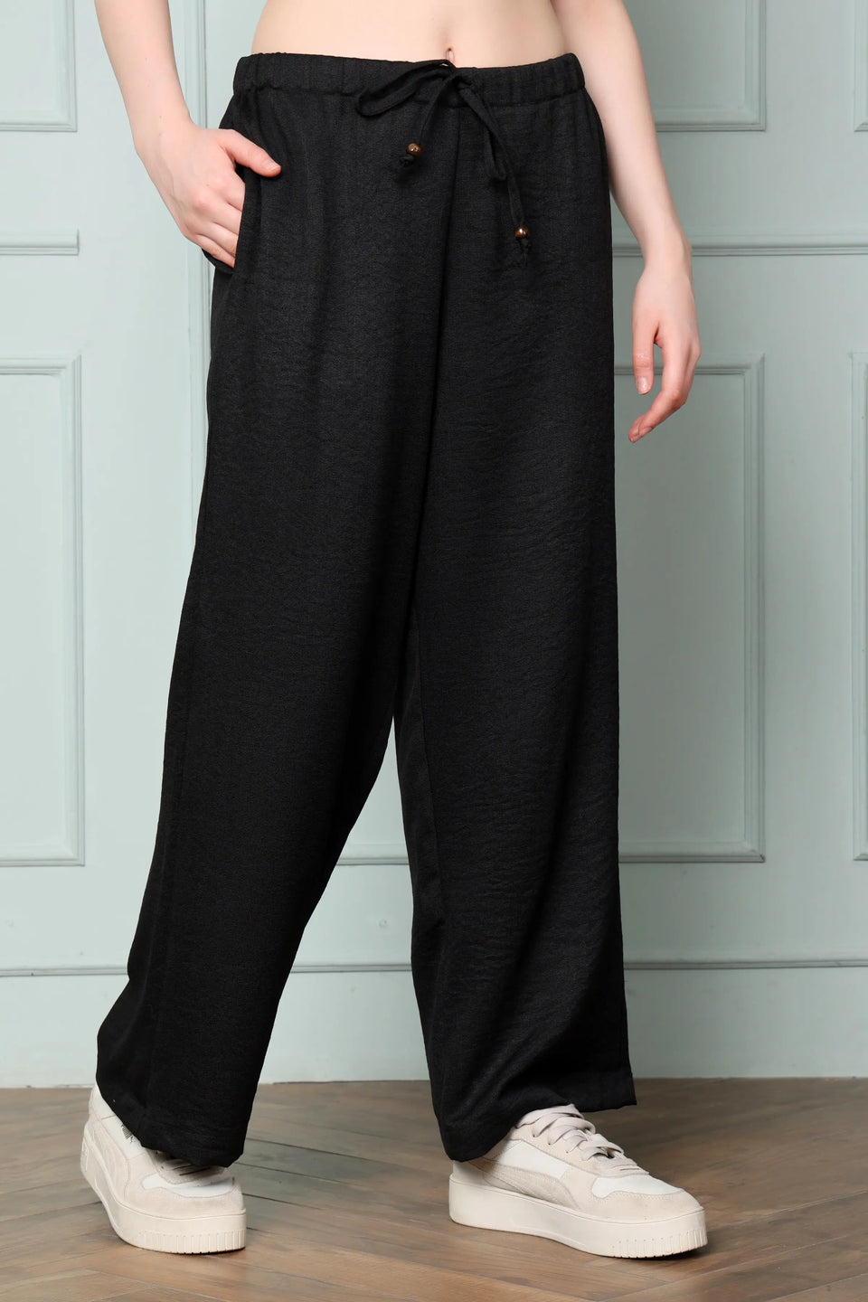 RABRIC black linen trousers for women side angle with broad wide leg silhouette and drawstring waist