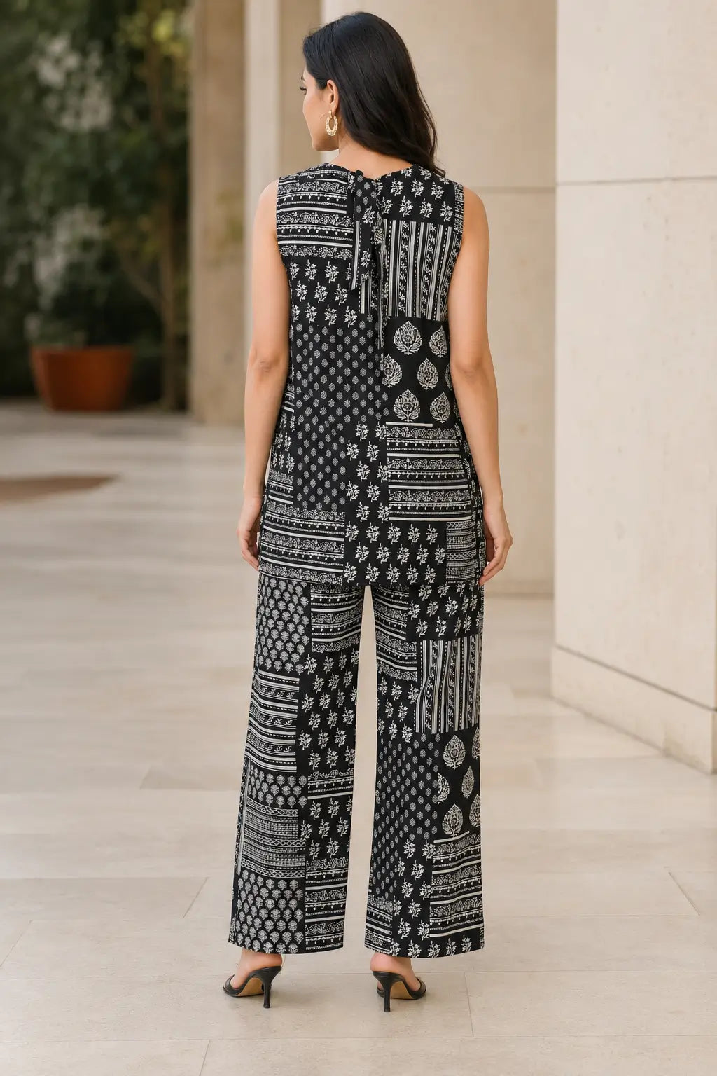 Back view of Rabric black off-white cotton flex sleeveless co-ord set with ethnic patchwork block print and wide-leg pants