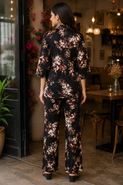 Rabric black rayon floral print women co-ord set back view with short collared shirt and wide leg pant