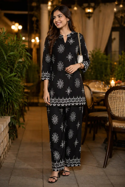 Rabric black Vertican Silk women co-ord set with white floral and geometric print, short kurta with 3/4 sleeves and matching wide leg pants front view