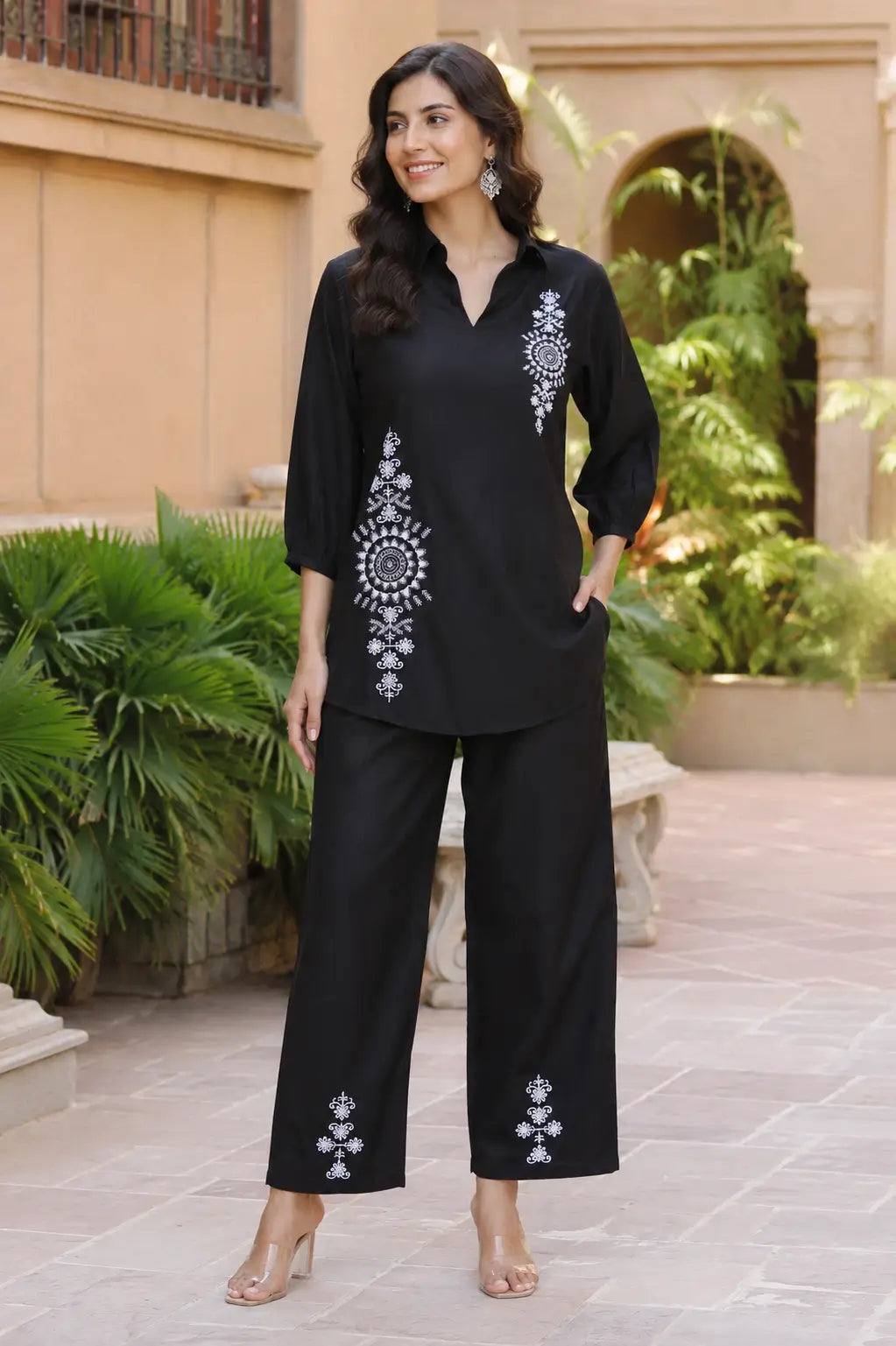 Rabric black vertican silk embroidered co-ord set for women featuring white mandala floral embroidery, collared neck, 3-4 sleeves and straight pants front view.