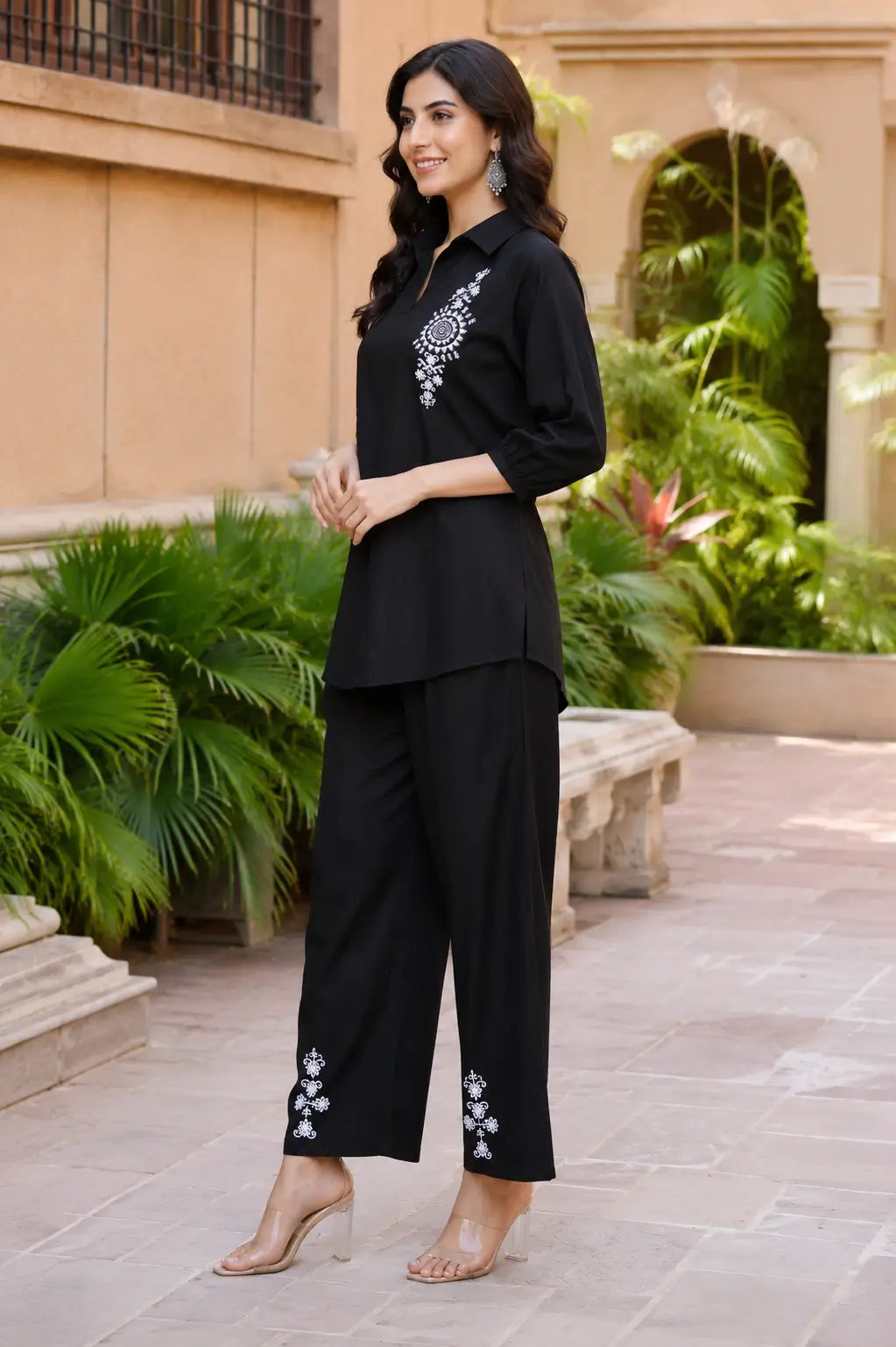 Side view of Rabric black vertican silk embroidered co-ord set featuring white floral mandala embroidery, collared shirt and straight fit pants.