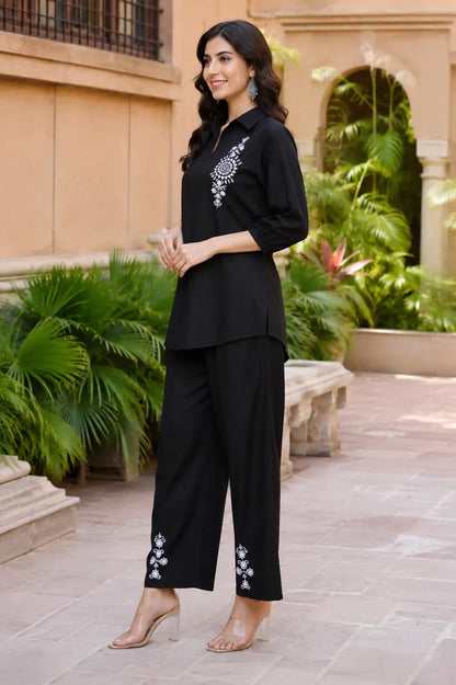 Side view of Rabric black vertican silk embroidered co-ord set featuring white floral mandala embroidery, collared shirt and straight fit pants.