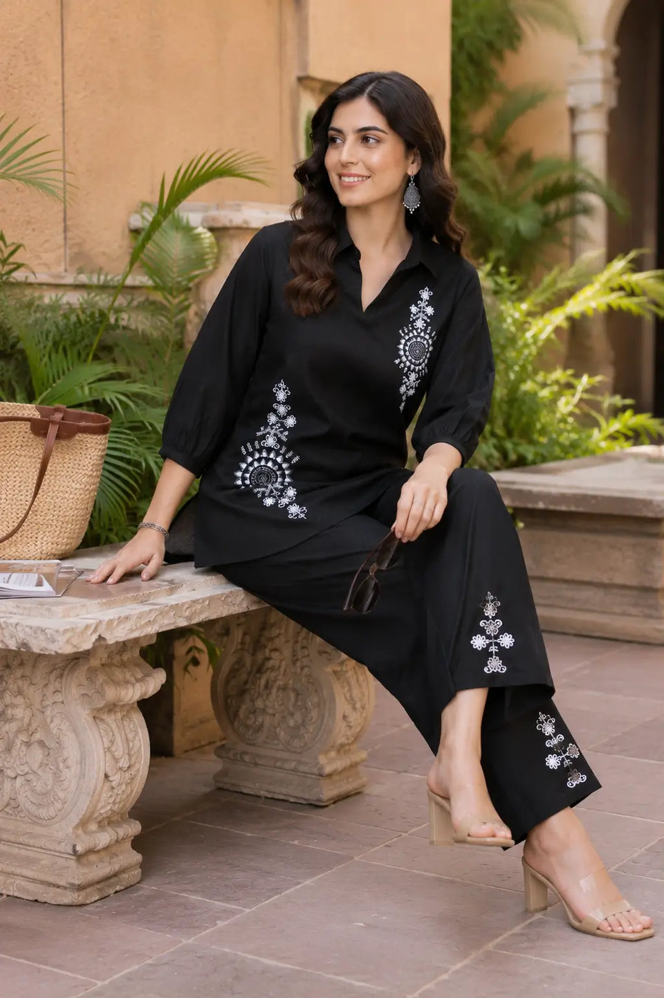 Rabric black vertican silk embroidered co-ord set for women in a casual sitting pose showcasing white mandala floral embroidery and premium fabric texture.