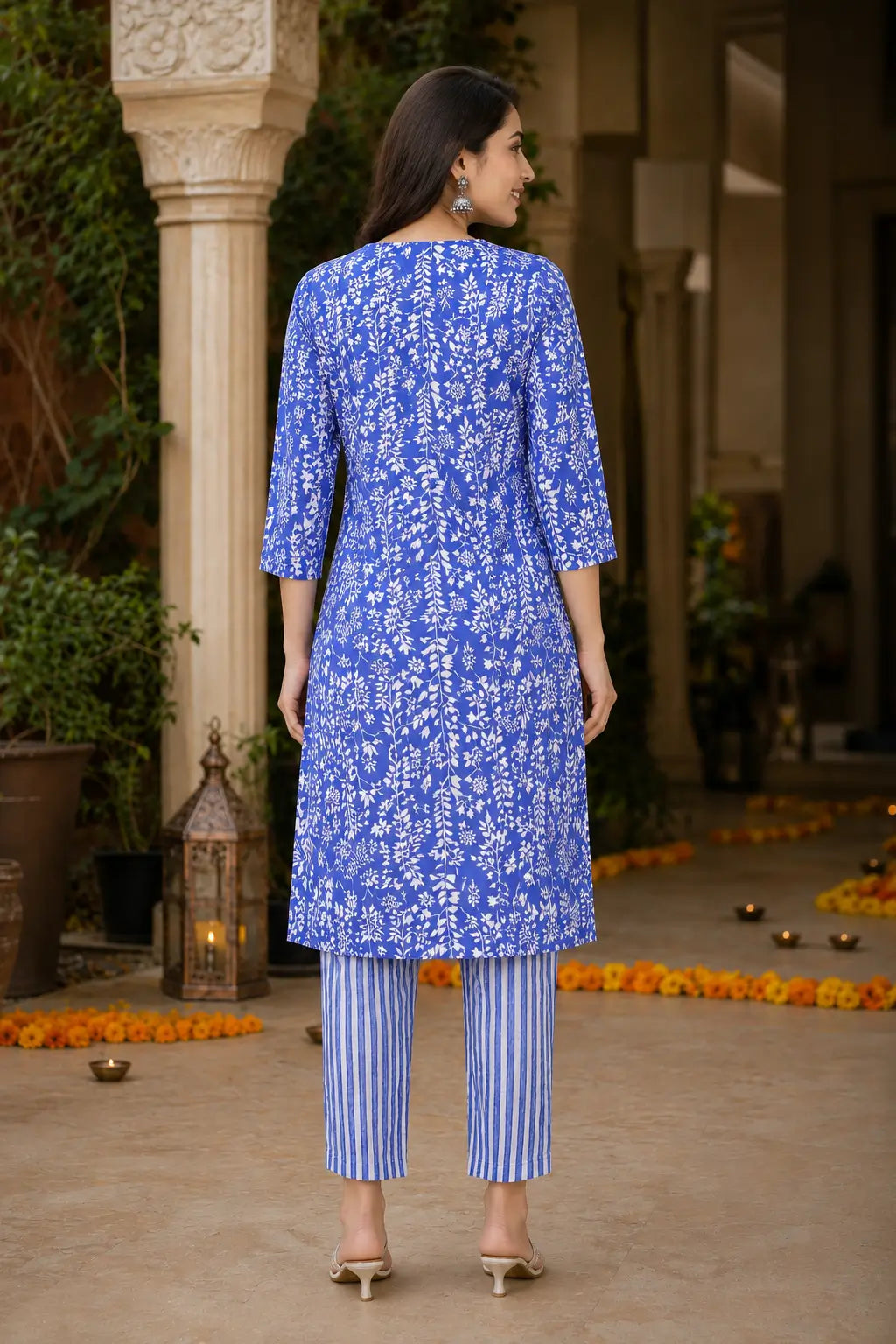 Back view of Rabric blue botanical print cotton kurta pant set for women with straight striped cotton pants
