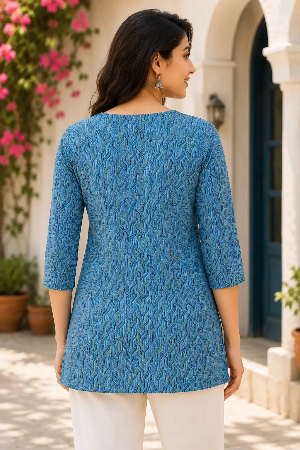 Back view of Rabric blue cotton printed mid length short top with side slit and 3/4 sleeves for women
