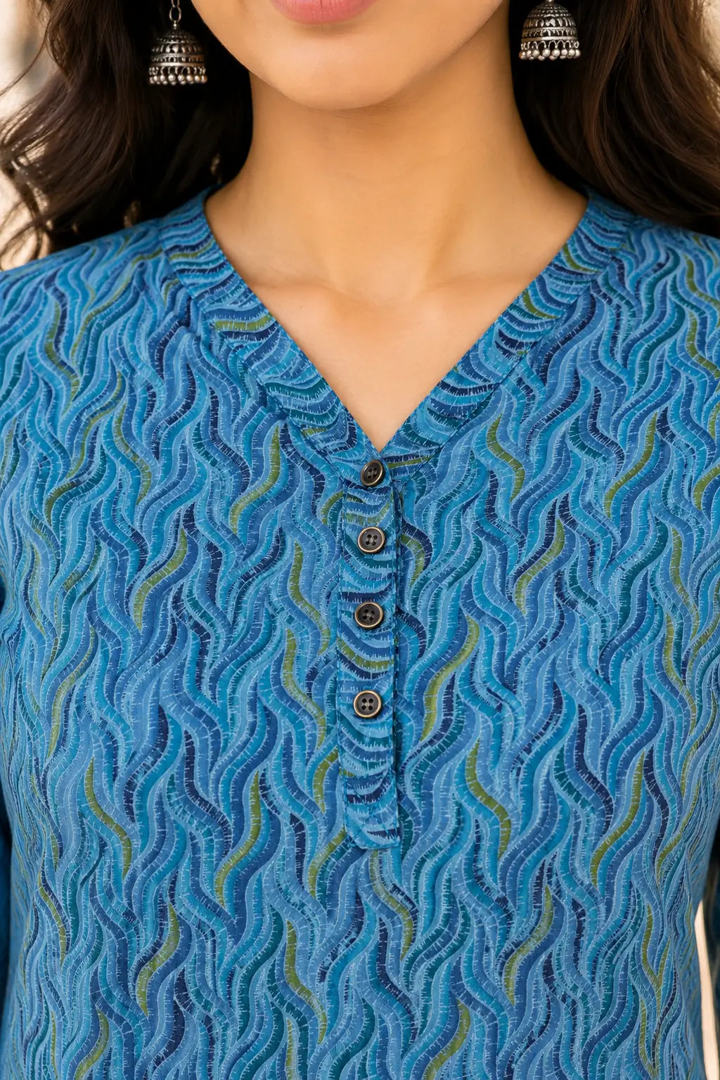 Closeup neck design of Rabric blue cotton printed women short top with stylish V neck and button detailing
