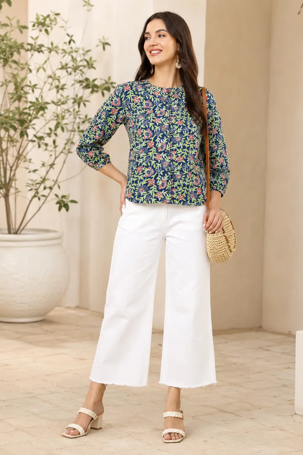 Woman wearing Rabric blue floral cotton short top styled with white wide leg pants for casual chic fashion