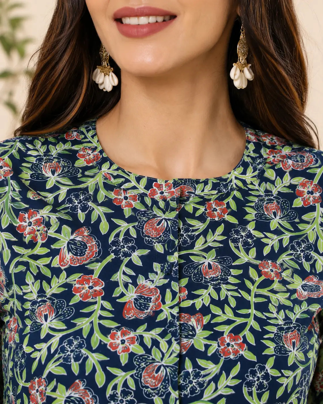 Closeup round neck design of Rabric blue floral cotton shirt style short top with front button detailing