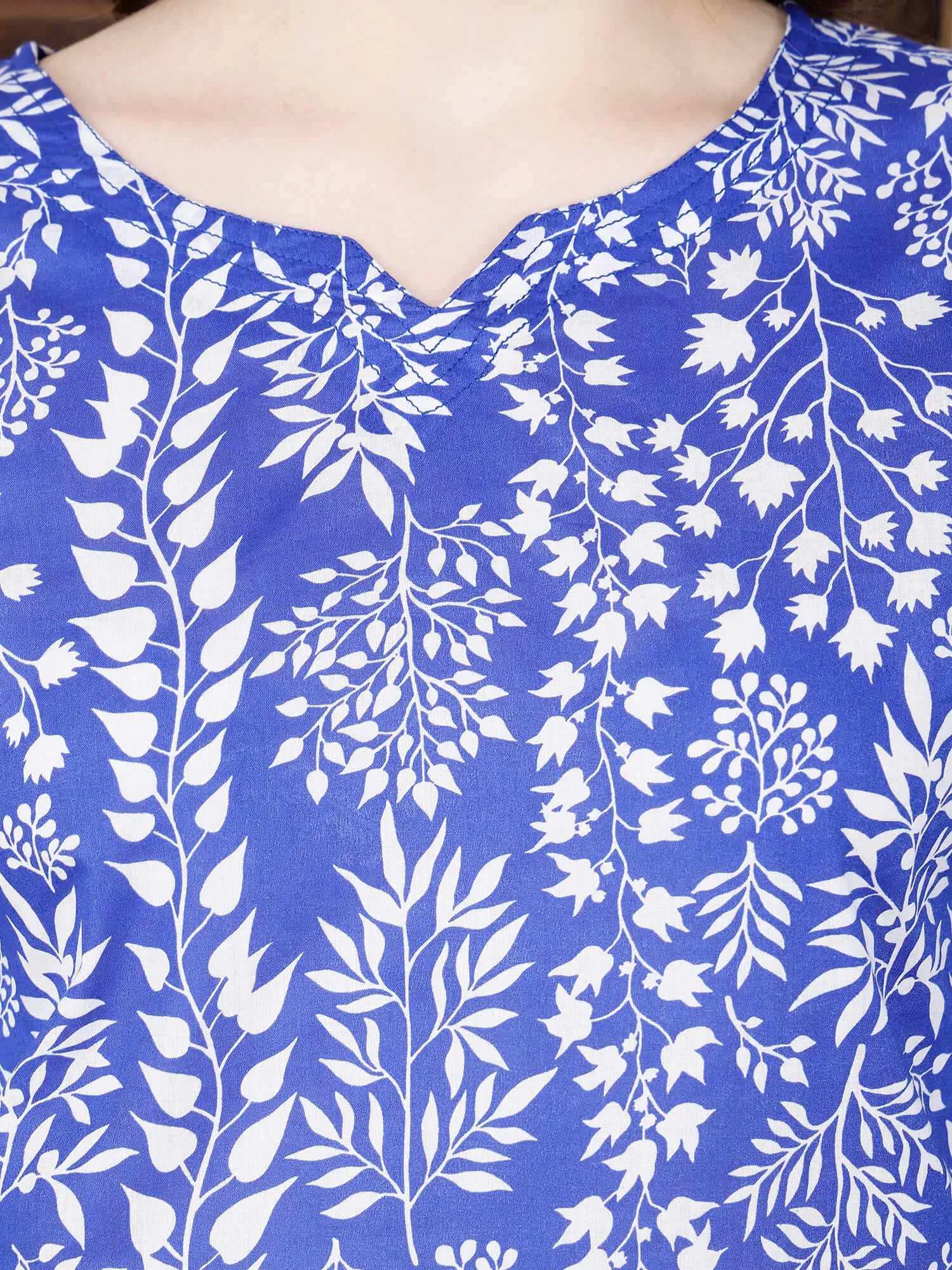 Close-up of floral print blue cotton kurti with brass buttons