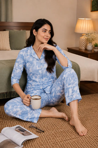 Rabric women’s blue glace cotton sleepwear co-ord set in casual sitting pose with cozy bedroom accessories