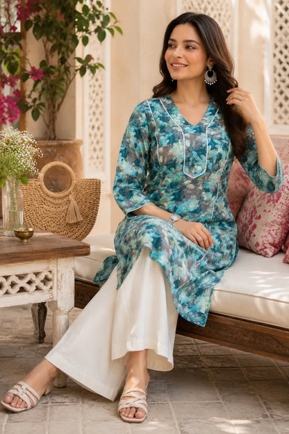Rabric women floral cotton kurti in blue grey color casual sitting pose with stylish accessories and palazzo pants