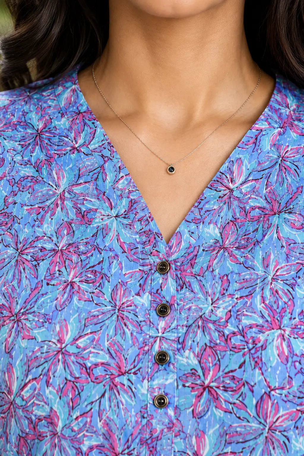Close up neck design of Rabric blue pink floral cotton short top featuring stylish V neck and button detailing