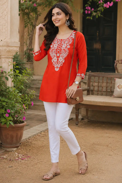 Stylish woman wearing red cotton embroidered short kurti with casual accessories outdoor lifestyle look