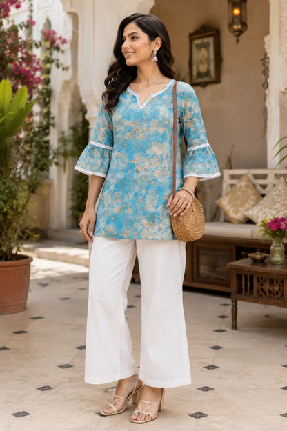 Stylish women wearing blue floral cotton short top with white palazzo pants casual ethnic look