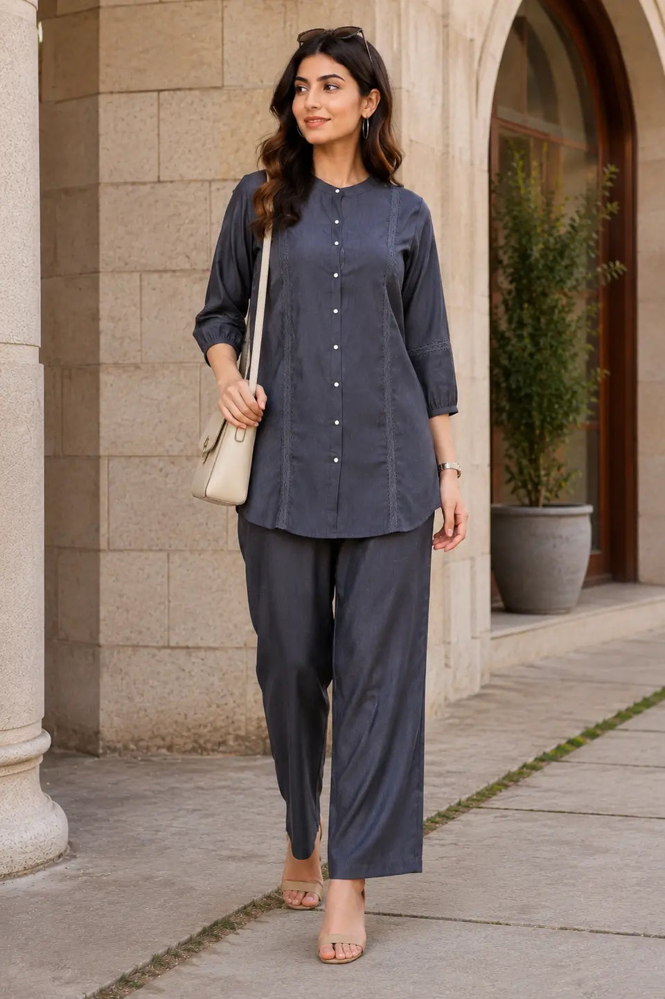 Woman wearing Rabric charcoal grey Vertican Silk co-ord set styled for smart casual outings with elegant lace detailing and straight trousers.